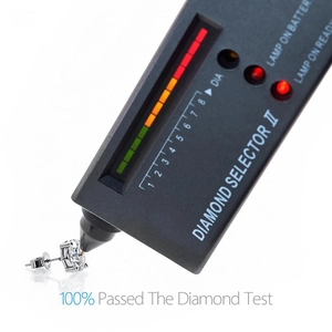 Moissanite earrings being verified with a Diamond Selector II tool showing a pass result
