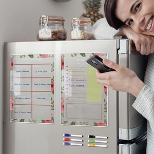 Macro detail of acrylic magnetic weekly planner and to-do list on stainless steel fridge