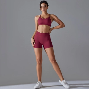 Detailed close-up of seamless knit texture on the burgundy yoga bra and shorts set