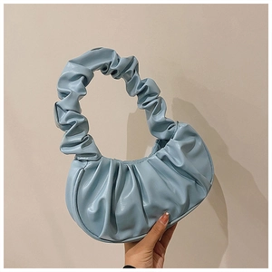 Detailed view of light blue pleated PU leather material and ruched handle on the bag