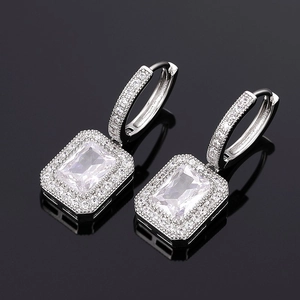 Silver square-cut drop earrings with halo micro-pave stones on high-gloss mirror background