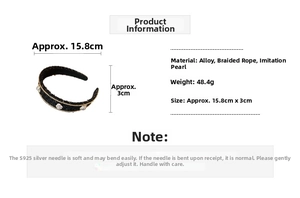 Detail view of black woven headband with faux pearl accents and gold chain trim