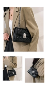 Close-up of black quilted chain strap bag featuring elegant flap lock and diamond pattern