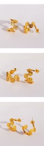 Macro view of gold coin relief earrings with vintage textured circular metallic finish