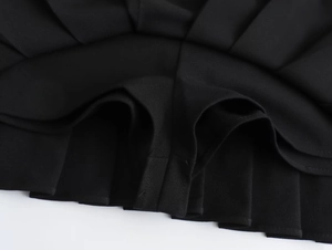 Detail view of the black pleated skirt with a built-in safety lining for comfort