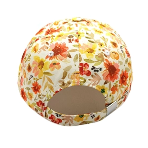 Close-up of floral baseball cap back with adjustable silver metal buckle and twill fabric