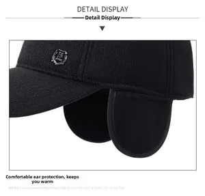 Detail view of winter black hat with ear flaps and side shield logo for cold protection