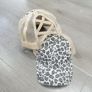 Leopard print mesh baseball cap with criss-cross elastic ponytail holder shown in 45-degree view