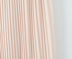 Detail shot of light pink pleated chiffon fabric with elegant vertical textures