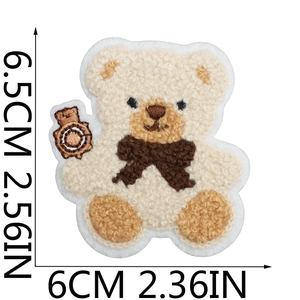 Detail view of curly bear embroidery patch showing size 6.5cm by 6cm with towel texture