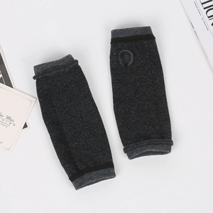 Detailed texture of dark grey striped knit fingerless arm warmers with thumb hole
