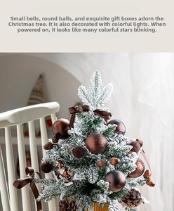 Detailed view of mini flocked Christmas tree with pine cones and brown ribbon ornaments