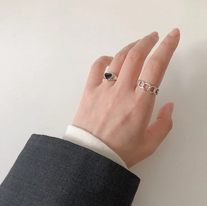 Detail showing retro S925 sterling silver black heart ring and Cuban chain stackable style