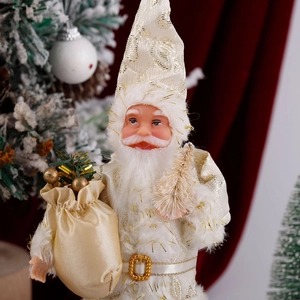 Detailed shot of plush Santa doll in ivory and gold holding a gift bag and mini tree
