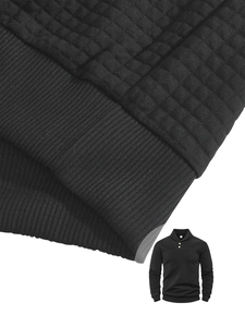 Detail of black polo neck sweatshirt featuring quilted waffle texture and ribbed hem line