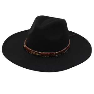 Detail of ethnic embroidery band and golden feather charm on black wide brim fedora hat