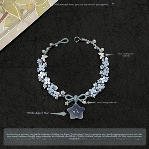 Detail of handmade S925 silver bracelet with blue woven flowers and white agate star
