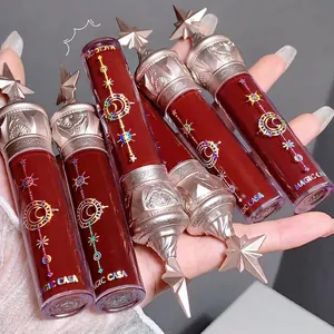 Set of liquid lip glosses with silver star-engraved caps and colorful shades