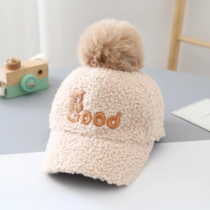 Detail of baby teddy fleece baseball cap with fluffy pom-pom and Good bear embroidery