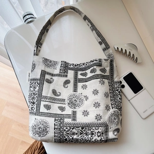 Retro black and white paisley cotton linen shoulder bag with a wide strap design