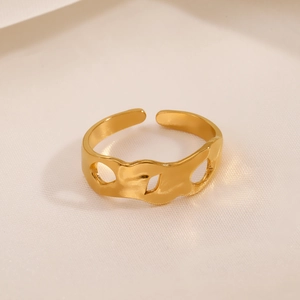 Irregular hollow wave ring in gold stainless steel with minimalist geometric open design