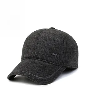 Detailed close-up of dark grey winter baseball cap featuring wool fabric and metal logo