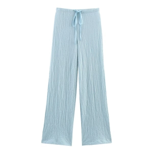 Detail of light blue wide leg trousers with drawstring waist and pleated knit texture