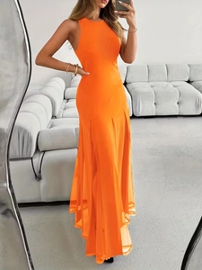 Detail of elegant orange sleeveless long dress with sheer split hem and chic halter neck