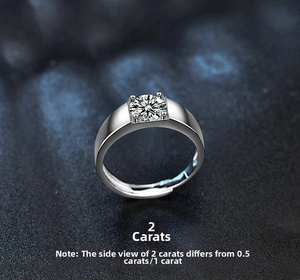 Close-up of 2 carat moissanite ring with wide polished silver band and four-prong setting