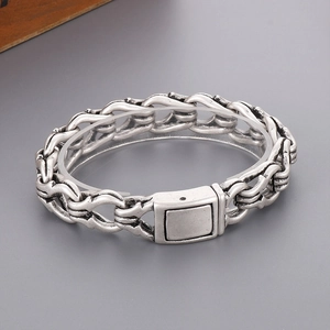 Detail of vintage punk silver bracelet featuring interlocking links and heavy square clasp