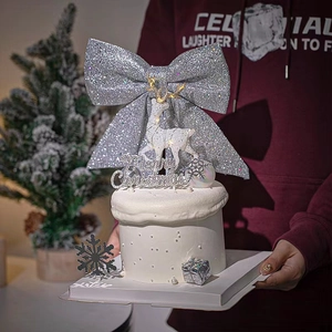 Silver glitter bow and white reindeer cake topper set for Christmas baking decoration