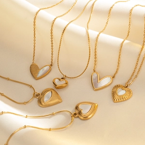 Elegant 18k gold plated heart pendant necklaces with white shell on beige silk background
