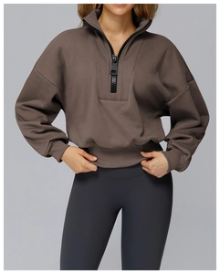 Detail view of coffee brown half-zip sweatshirt with high neck and black zipper detail