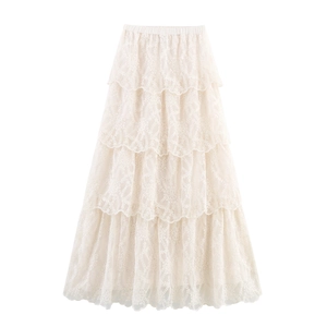 Elegant bohemian off-white layered lace maxi skirt with a tiered A-line silhouette