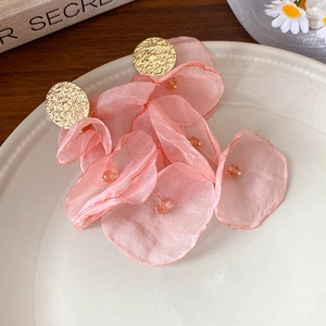 Handmade pink chiffon flower earrings with gold studs and pearl accents in a ceramic tray