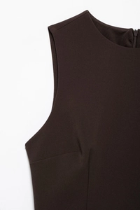 Detail of deep brown sleeveless dress featuring a seamless back zipper and round neck