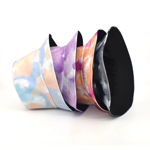 Tie-dye reversible bucket hats in blue, purple, orange, and gray for summer outdoor style