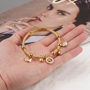 18K gold plated stainless steel wire cross bracelet with sparkling crystals and charms