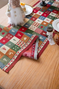 Detailed texture of festive Christmas table runner with reindeer and tree patterns
