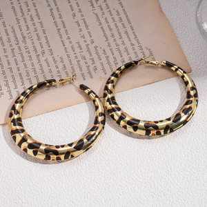 Chic leopard print geometric gold hoop earrings with retro aesthetic on a vintage background