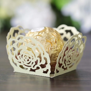 Detail of laser-cut rose lace candy wrapper in cream paper with elegant hollow pattern