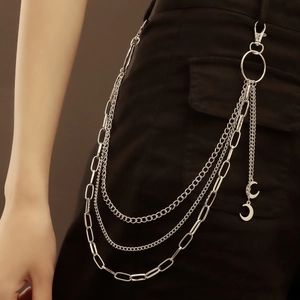 Detail of silver multi-layer metal pants chain featuring crescent moon pendants and lobster clasp