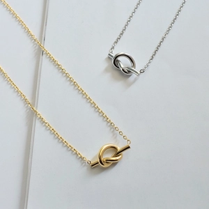Minimalist knot pendant necklaces in gold and silver finish with sleek titanium steel chains