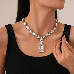 Close-up of luxury silver-tone choker necklace with crystal waterdrop and square pendants
