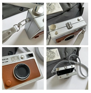 Detail view of retro camera shaped crossbody bag featuring metallic lens and interior