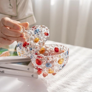 Detail shot of hands opening a colorful bubble-textured glass storage jar with lid