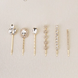 Set of six gold metal hair clips with clear sparkling rhinestones in various shapes