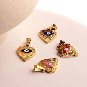 Four golden heart pendants with evil eye designs in blue, black, red, and pink colors