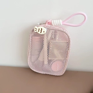 Detail of pink mesh makeup bag featuring pearl zipper pull and portable hand strap