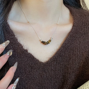 Tiger eye beaded pendant necklace on a silver chain worn with vintage knitwear